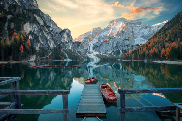One of the best places to visit in Italy is Lago di Braies in the Dolomites, featuring turquoise water, traditional wooden rowboats, and the reflecting Seekofel mountain - Image by istockphoto.com.