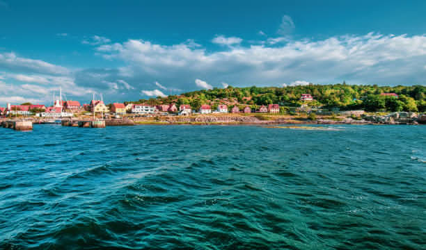 10 Best Places To Visit In Europe In Summer Red houses along the green coastline of Bornholm, a scenic summer secret in Denmark - Image by iStockphoto.com