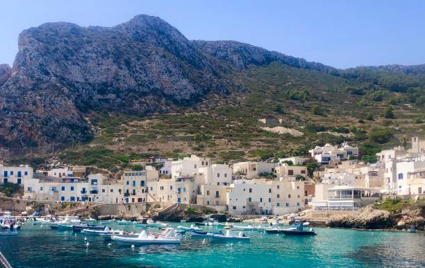 10 Best Places To Visit In Europe In Summer Turquoise water at Cala Rossa beach in Favignana, Italy. A perfect place to visit in Europein summer - Image by iStockphoto.com